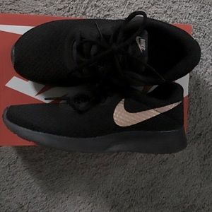 Nike tennis shoe with Rose Gold Nike sign